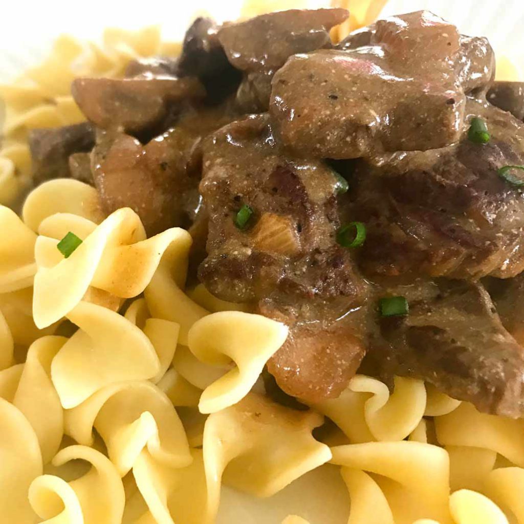 Beef stroganoff serving with egg noodles