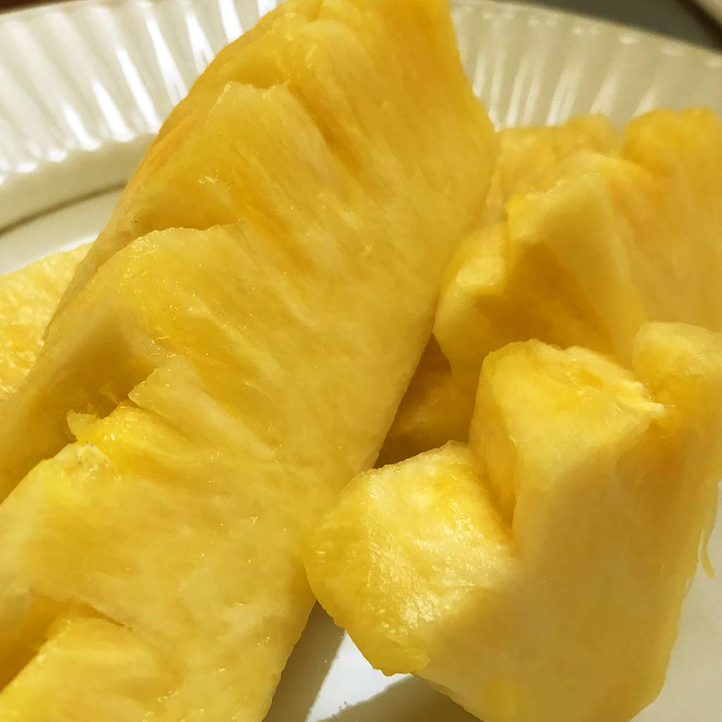 fresh cut pineapple are displayed in a play