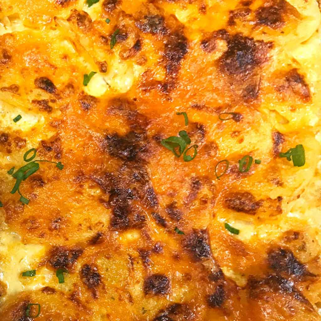 cheesy scallop potatoes, garnish with green onion