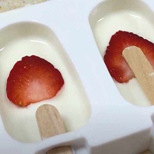 place strawberry into the cakesicle mold
